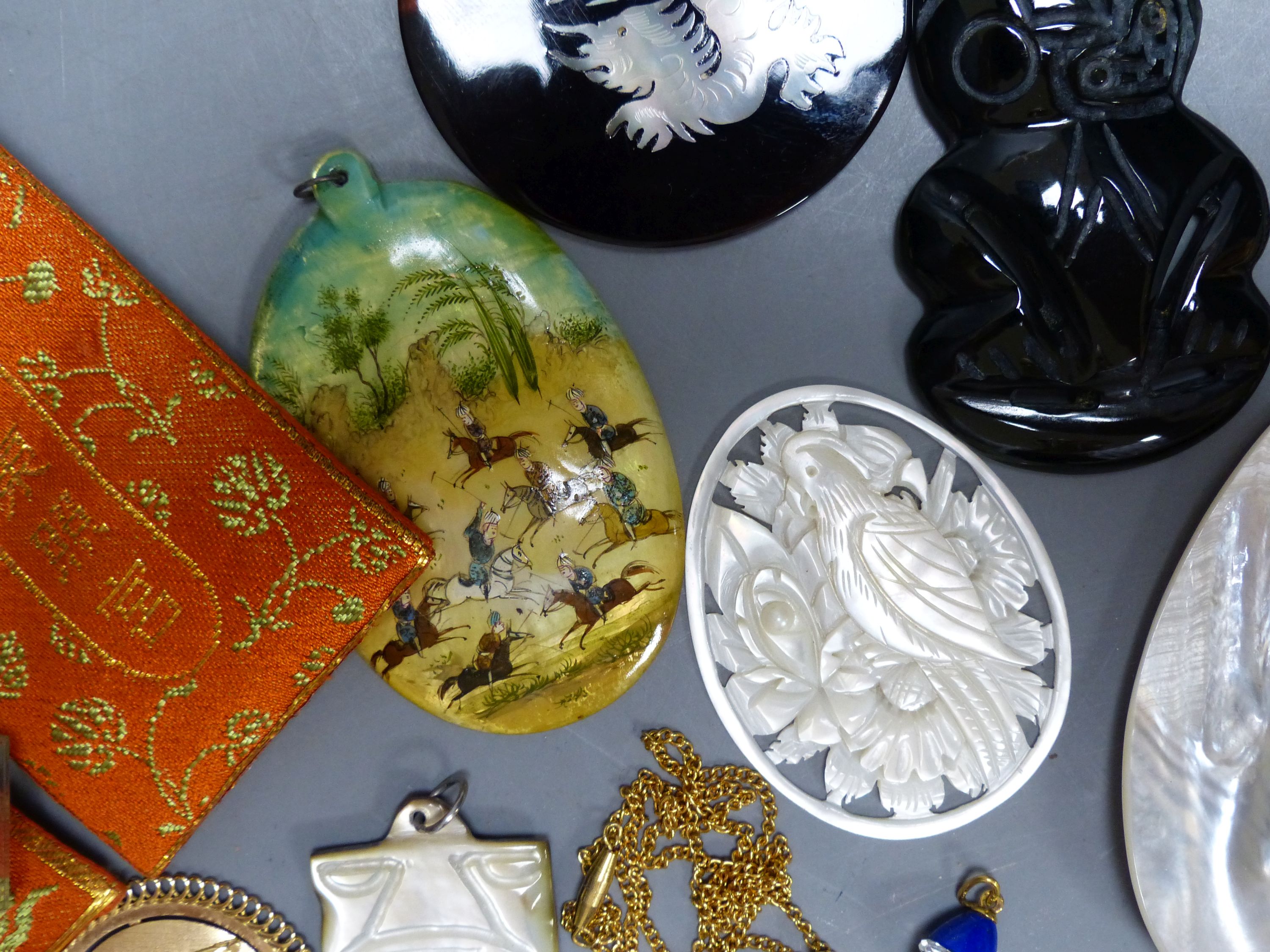 Miscellaneous decorative items, including a Mughal oval miniature on mother of pearl of polo players, a black painted hardstone tiki